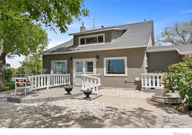 36340 County Road 49, Eaton, CO 80615 - back of house with stucco siding, a chimney, and a shingled roof