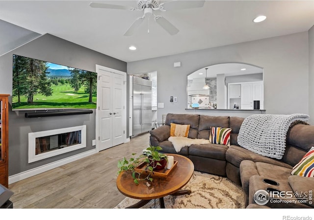 36340 County Road 49, Eaton, CO 80615 - living area with wood finished floors, a ceiling fan, recessed lighting, and arched walkways
