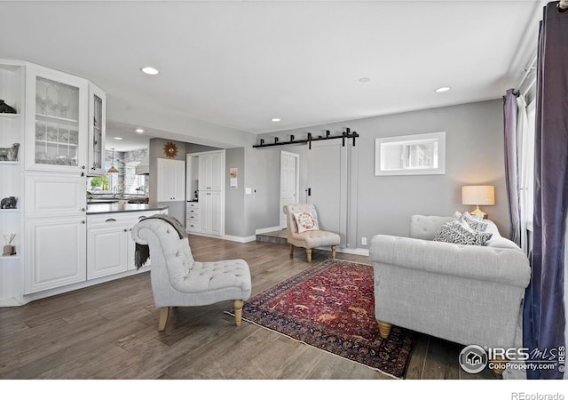 36340 County Road 49, Eaton, CO 80615 - living room featuring a barn door, wood finished floors, and recessed lighting