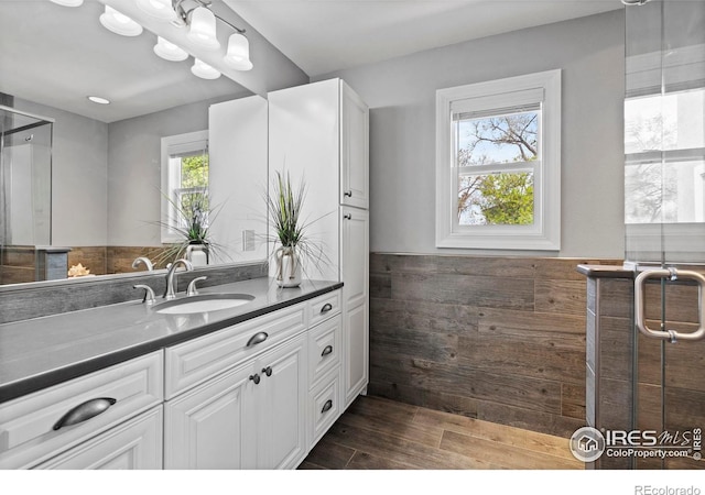 36340 County Road 49, Eaton, CO 80615 - bathroom with vanity, wood finished floors, and wainscoting