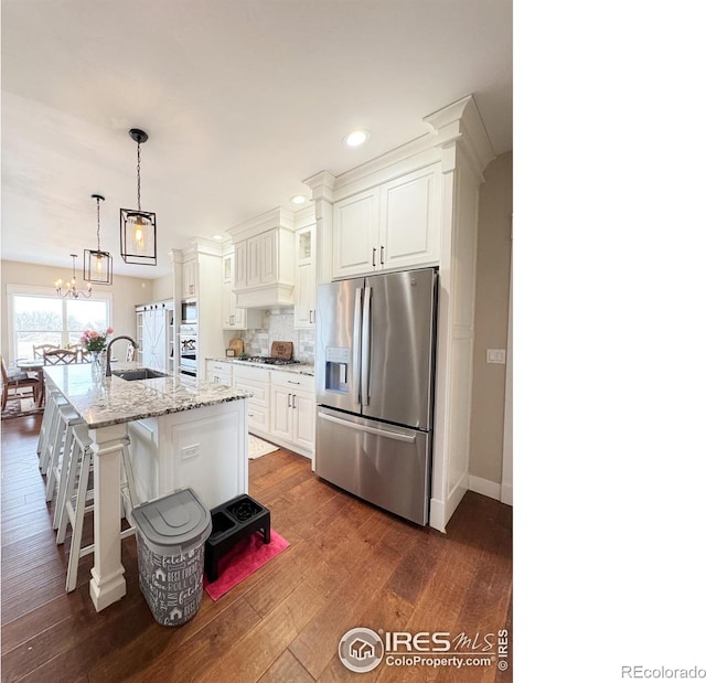 kitchen featuring white cabinets, dark wood-style floors, tasteful backsplash, and stainless steel appliances