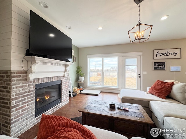 living room featuring a fireplace, wood finished floors, and recessed lighting