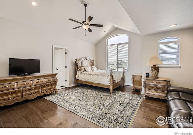 bedroom featuring lofted ceiling, multiple windows, baseboards, and wood finished floors