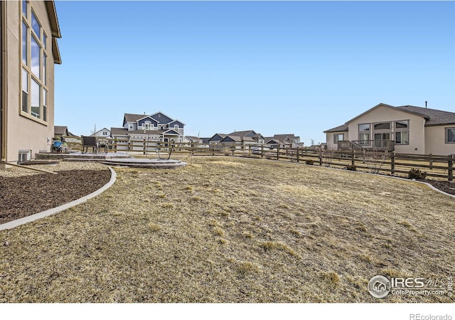 view of yard featuring a residential view and fence