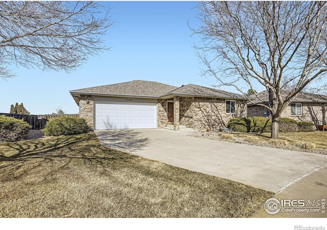 view of front of home featuring brick siding, concrete driveway, an attached garage, a front yard, and fence