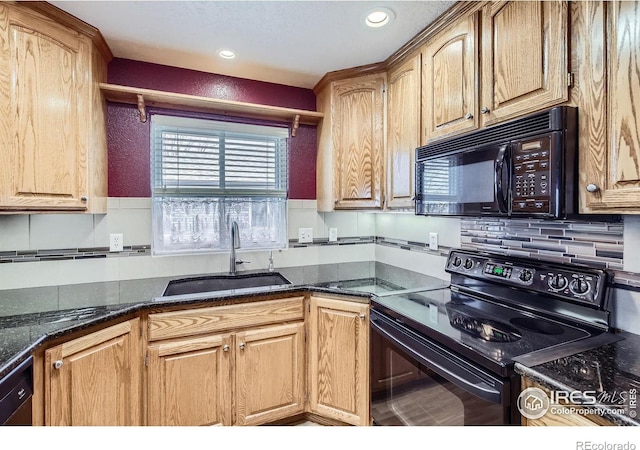 kitchen featuring black appliances, dark stone countertops, decorative backsplash, and a sink