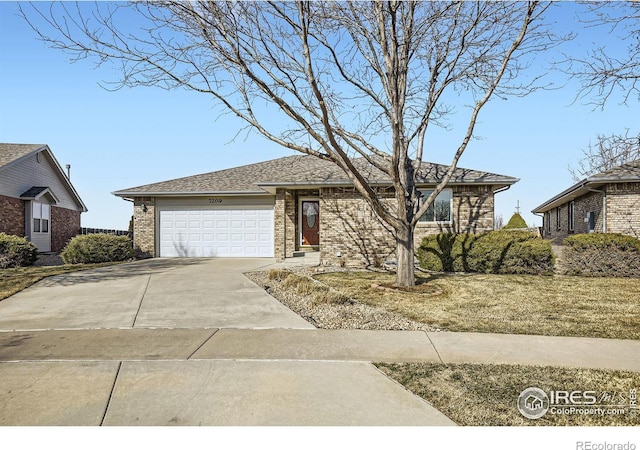 ranch-style house featuring driveway, an attached garage, and brick siding