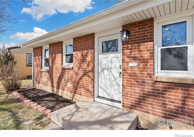 entrance to property with brick siding