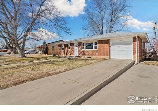 single story home featuring a garage, crawl space, driveway, and brick siding