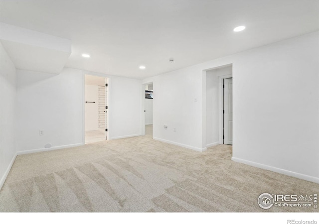 carpeted spare room with baseboards and recessed lighting