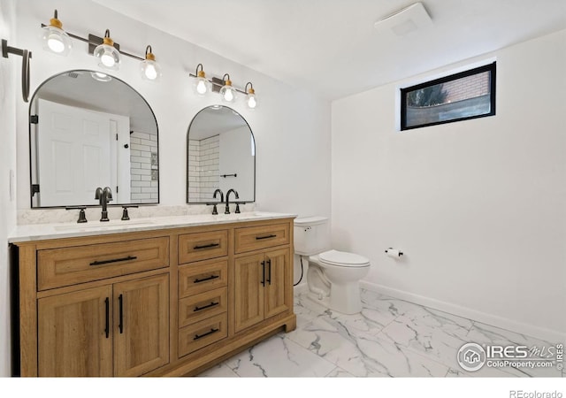 full bath with toilet, a sink, baseboards, marble finish floor, and double vanity