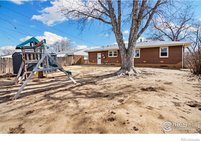 view of yard featuring a playground and fence