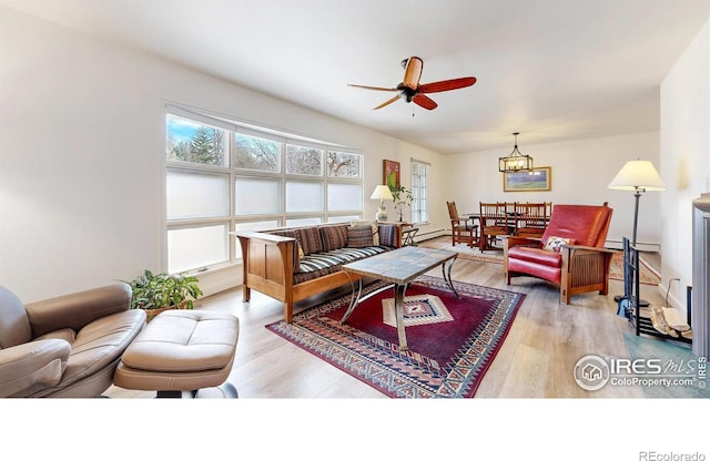 living room featuring light wood finished floors and a ceiling fan