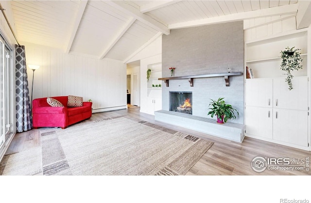 living room with vaulted ceiling with beams, a baseboard radiator, a fireplace, wood finished floors, and built in features