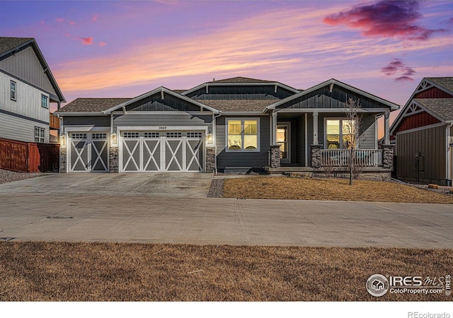 craftsman house with covered porch, driveway, and an attached garage