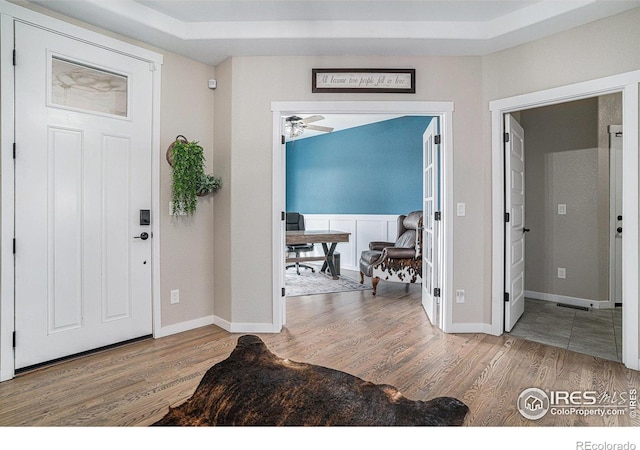 entryway featuring baseboards and wood finished floors