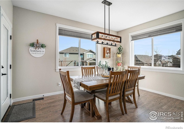 dining area with a healthy amount of sunlight, baseboards, and wood finished floors