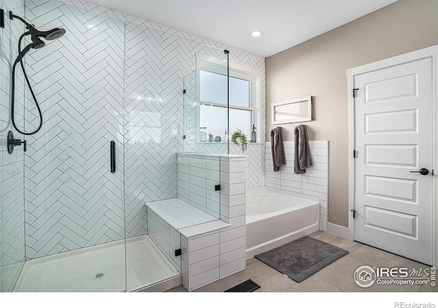 full bathroom with a garden tub, tile patterned flooring, and a stall shower