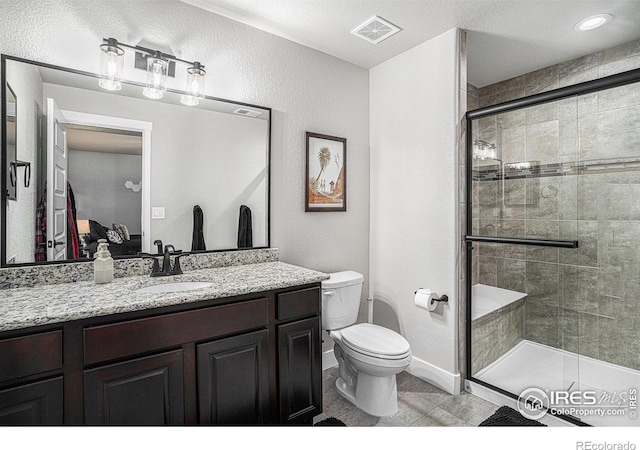 ensuite bathroom with visible vents, toilet, ensuite bathroom, vanity, and a shower stall