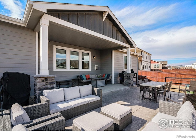 view of patio with outdoor dining area, fence, and an outdoor living space