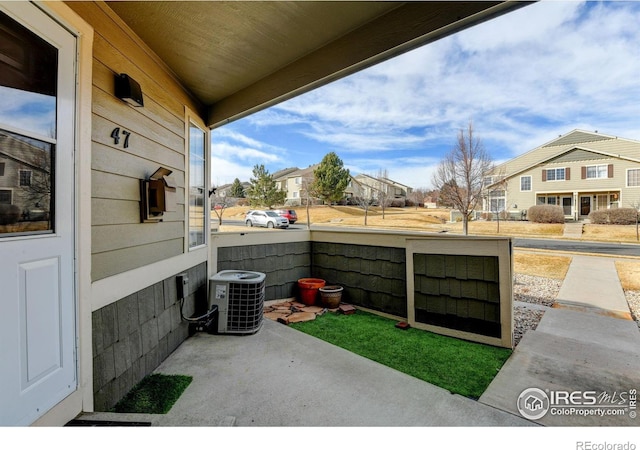 view of patio / terrace featuring a residential view and central AC