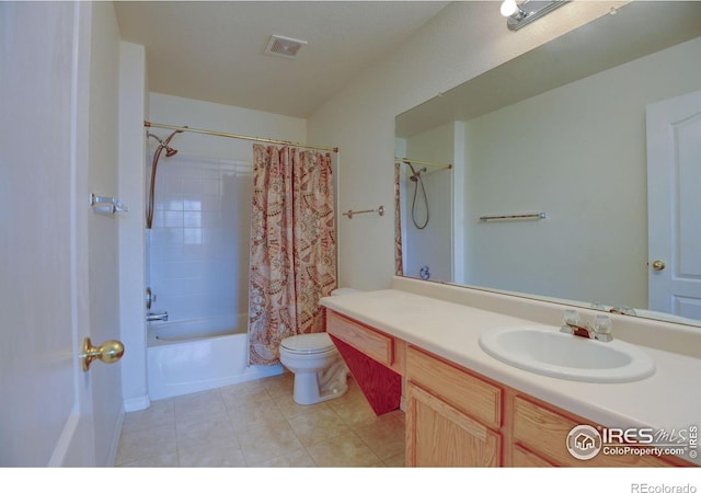 bathroom featuring vanity, visible vents, tile patterned flooring, shower / bath combo with shower curtain, and toilet