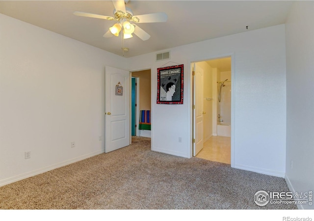 unfurnished bedroom featuring connected bathroom, carpet, visible vents, and baseboards