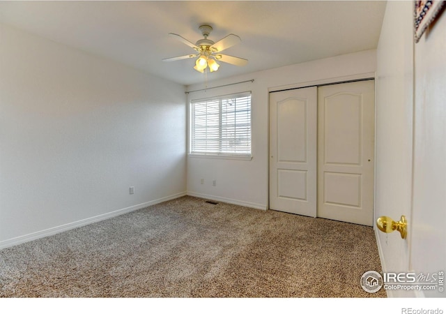 unfurnished bedroom with a closet, ceiling fan, baseboards, and carpet floors