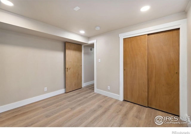 unfurnished bedroom featuring a closet, recessed lighting, light wood-type flooring, and baseboards