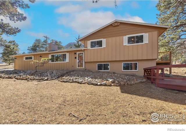 1059 Lexington Ln, Estes Park, CO 80517 - view of front of house featuring a deck, a chimney, and board and batten siding