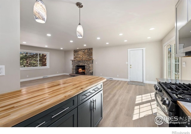 1059 Lexington Ln, Estes Park, CO 80517 - kitchen featuring wood counters, open floor plan, light wood-style floors, decorative light fixtures, and recessed lighting