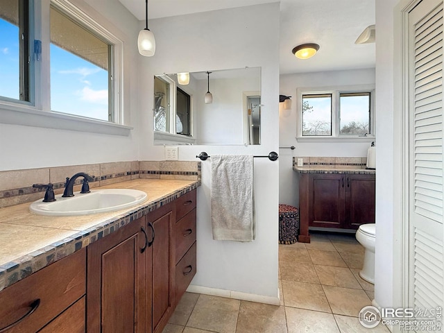 full bathroom with vanity, toilet, and tile patterned floors