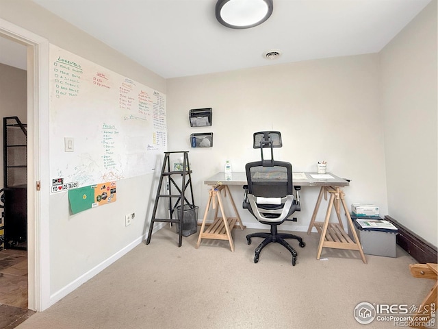 carpeted office with baseboards and visible vents