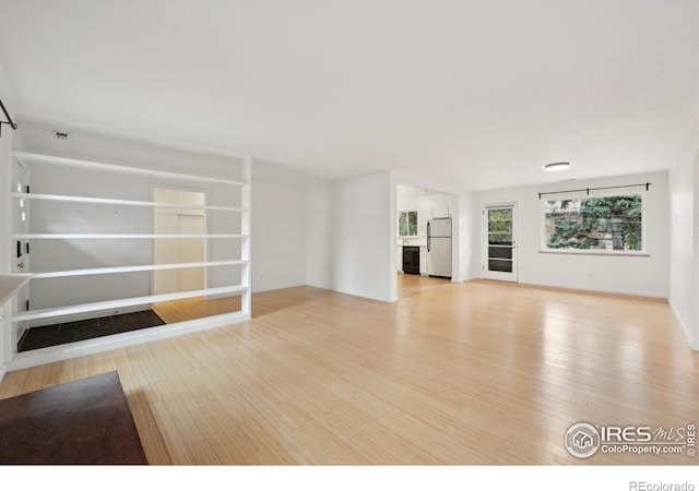 unfurnished living room featuring light wood finished floors