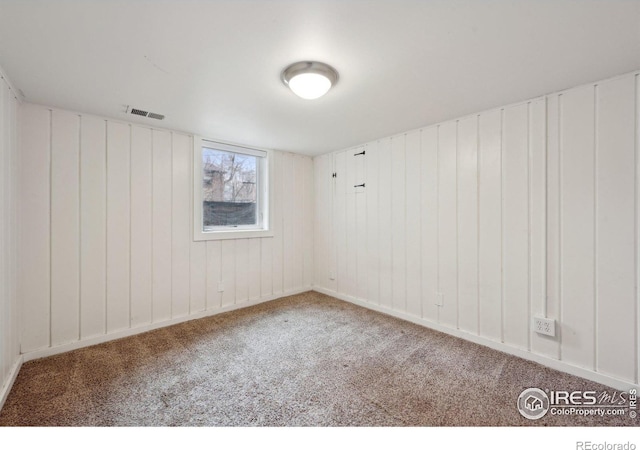 unfurnished room featuring carpet and visible vents