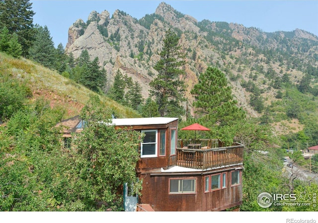 property view of mountains featuring a forest view