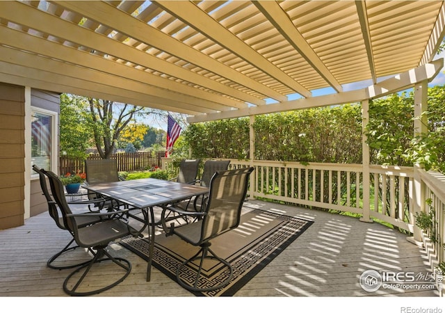 wooden deck featuring outdoor dining area, fence, and a pergola