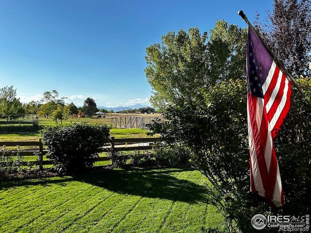 view of yard with a rural view and fence