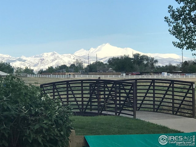 view of yard with an enclosed area, fence, and a mountain view