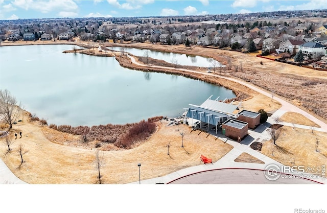 birds eye view of property featuring a residential view and a water view