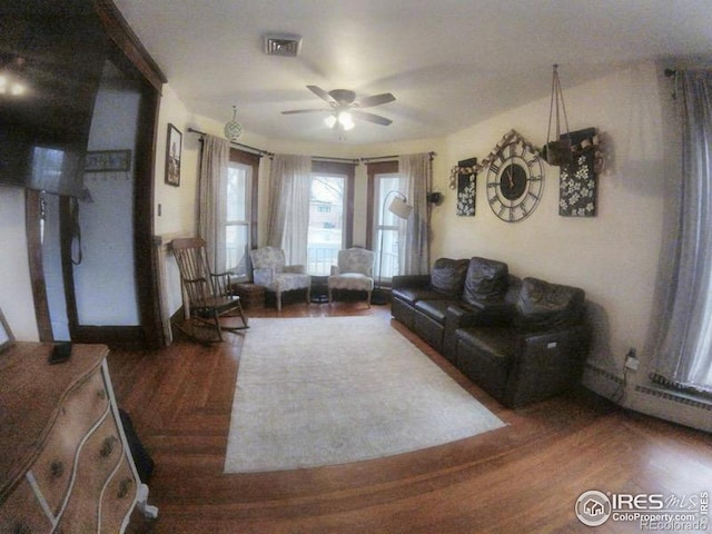 living area featuring ceiling fan, wood finished floors, and visible vents