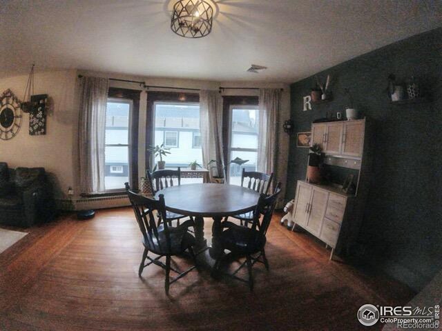 dining space featuring dark wood-type flooring and a healthy amount of sunlight