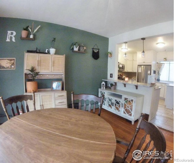 dining area featuring light wood-style floors