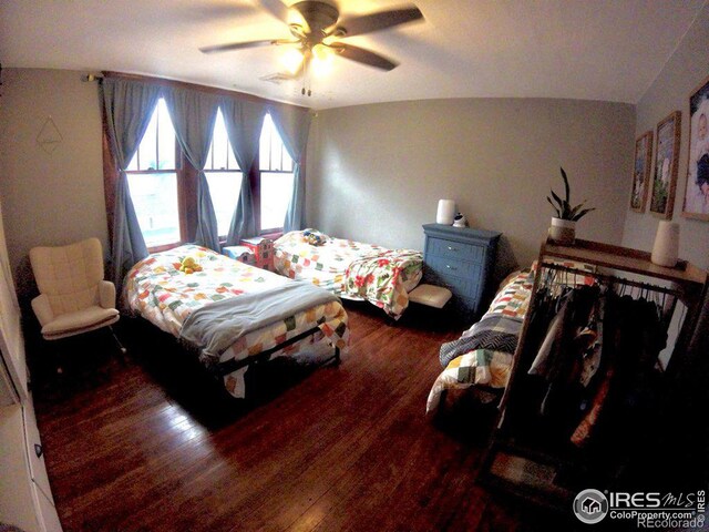 bedroom with a ceiling fan and wood finished floors