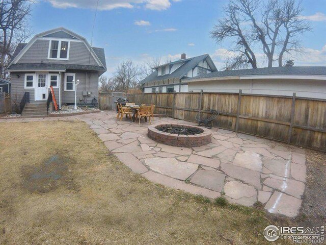 view of patio featuring an outdoor fire pit and fence