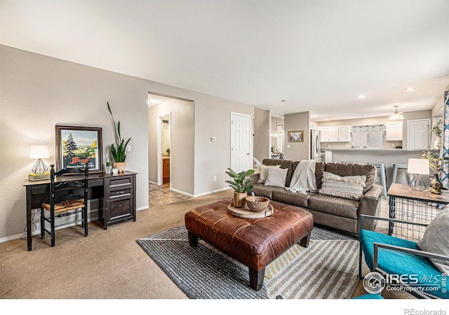 living area featuring light carpet and baseboards