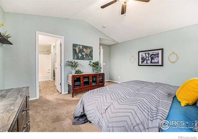 bedroom with carpet flooring, vaulted ceiling, ceiling fan, ensuite bath, and baseboards