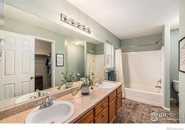 full bathroom with shower / tub combo with curtain, a sink, toilet, and double vanity