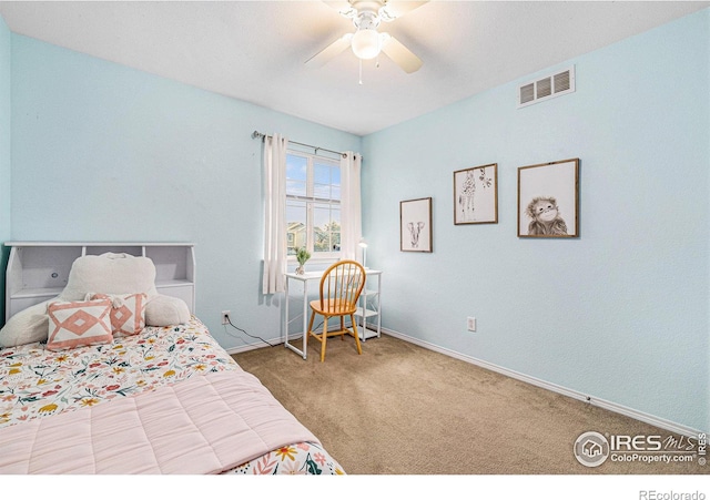 carpeted bedroom featuring a ceiling fan, visible vents, and baseboards