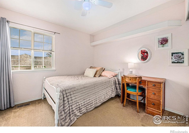 carpeted bedroom with baseboards, visible vents, and a ceiling fan